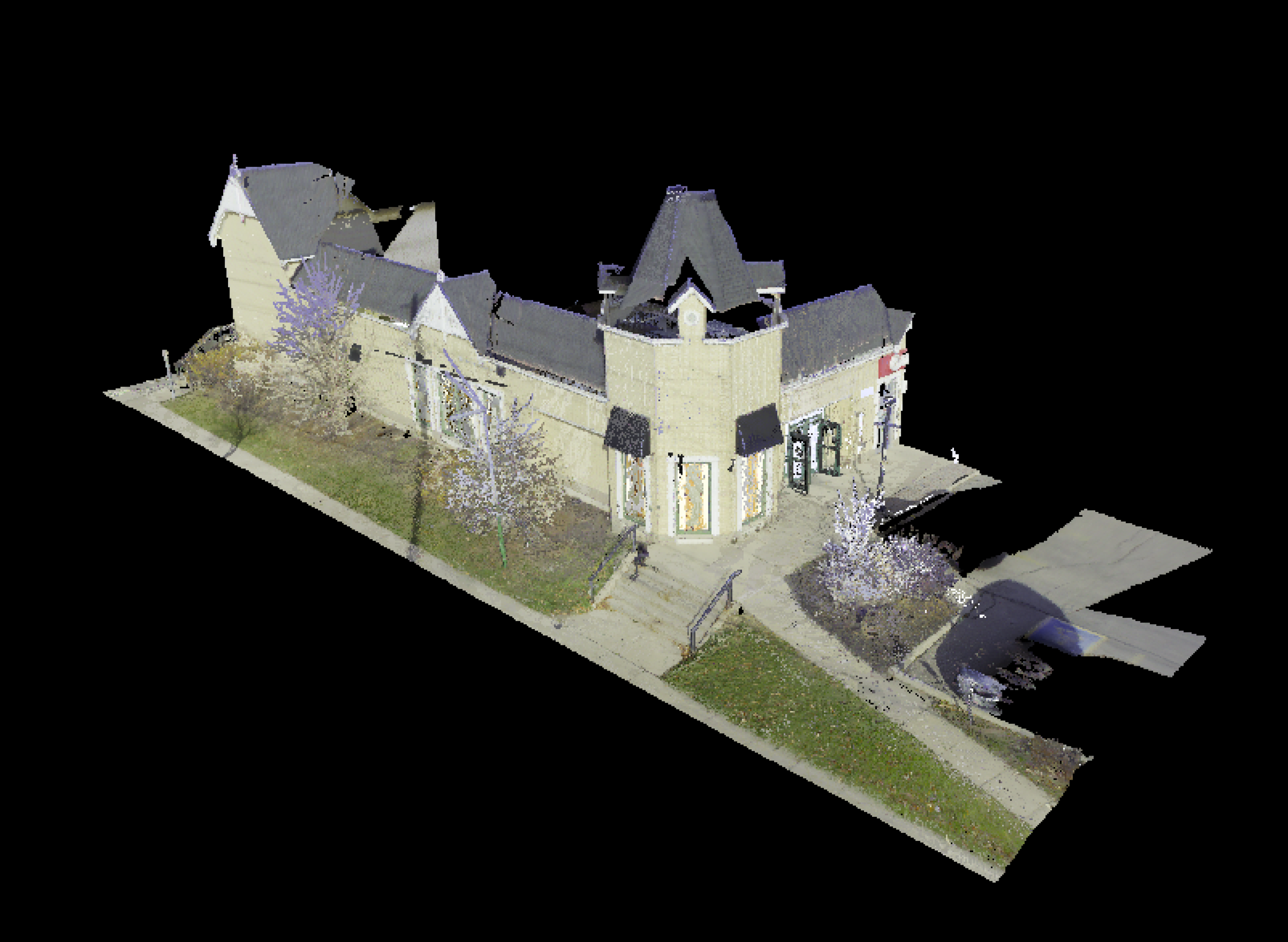 A 3D point‑cloud scan shows a small commercial building with pitched roofs, windows, and entrance steps, isolated on a black background. Surrounding sidewalks, grass, and nearby landscaping are partially captured in the scan.