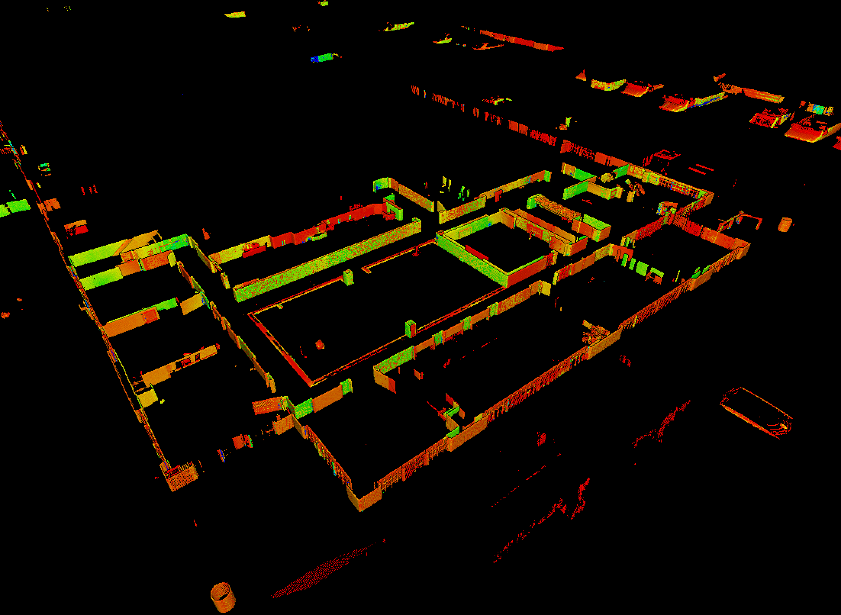 A color‑mapped 3D scan slice of a building interior, showing walls and room outlines highlighted in green, yellow, and red. The structure appears isolated on a black background, emphasizing spatial layout and geometry.
