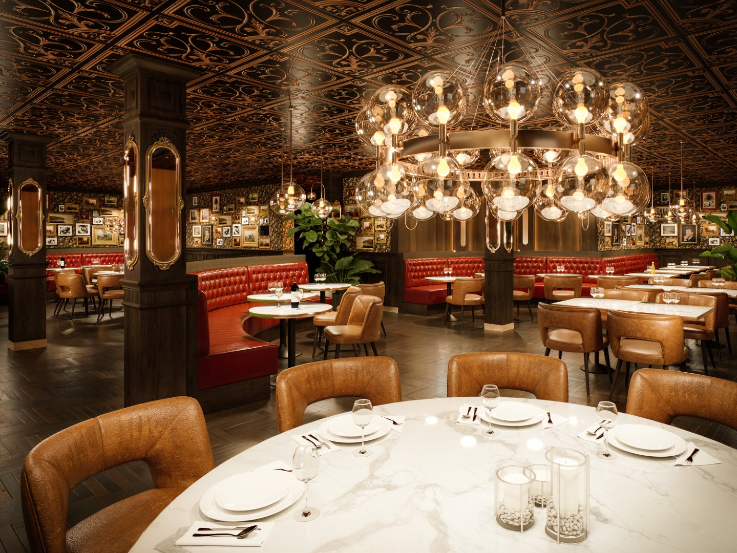 A refined restaurant dining room with marble‑topped tables, leather chairs, and red upholstered booths. Ornate ceiling panels and clusters of glass globe chandeliers create a warm, elegant atmosphere.