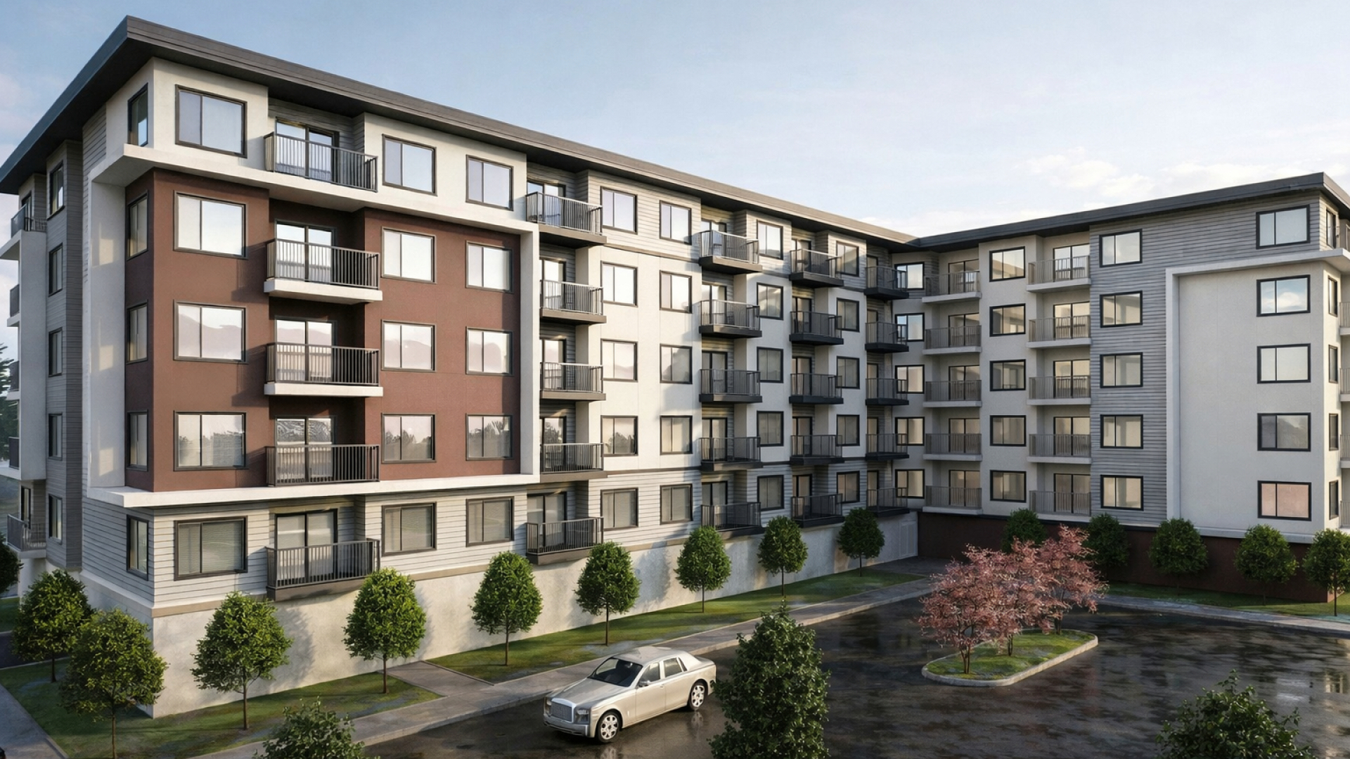 A rendered view of a mid‑rise apartment building with multiple balconies arranged around a landscaped courtyard and parked cars below. Trees and greenery line the walkways, and the building features light and dark exterior panels under a soft sky.